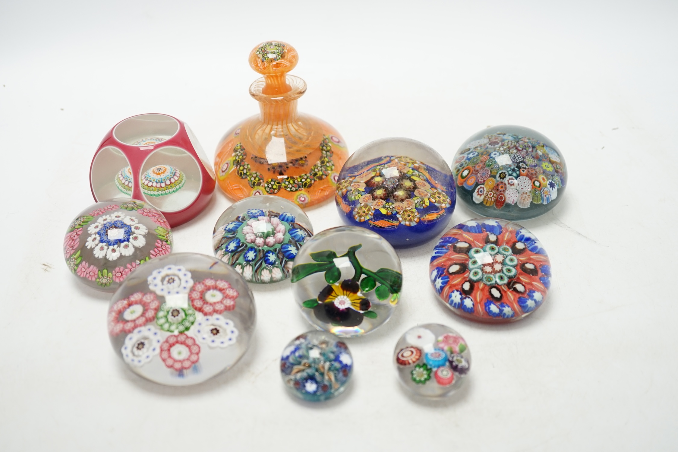 A collection of eleven glass paperweights, largest 10cm high. Condition - good